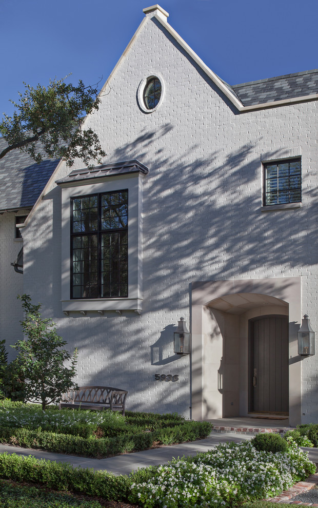 Großes, Zweistöckiges Klassisches Haus mit Backsteinfassade, weißer Fassadenfarbe und Satteldach in Houston