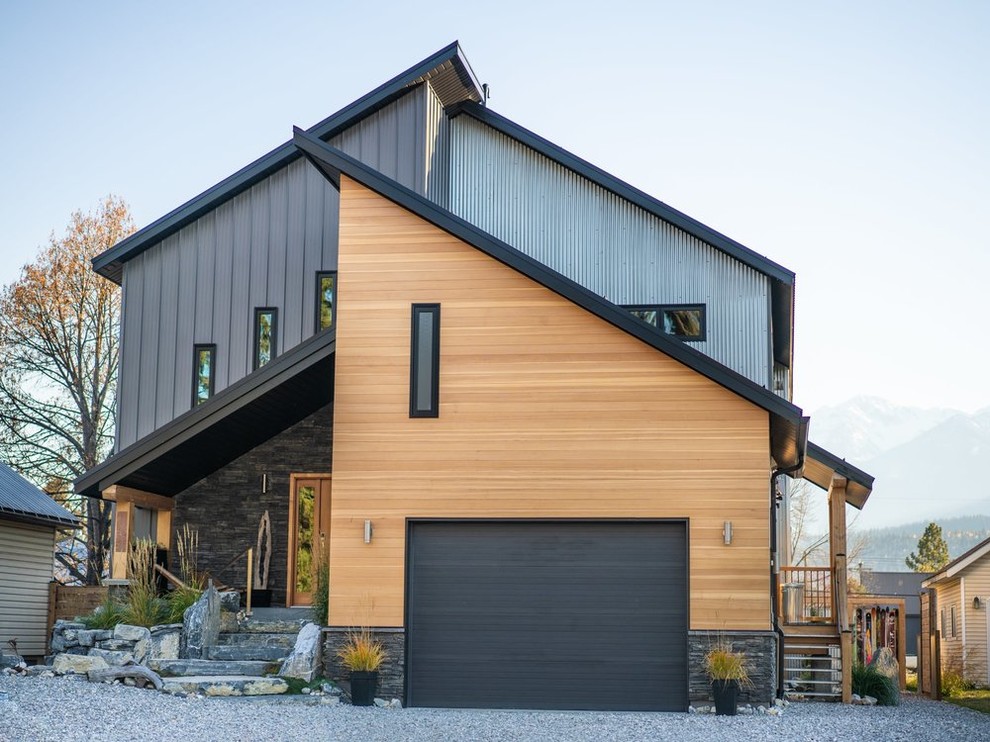 Example of a large minimalist two-story mixed siding exterior home design in Other