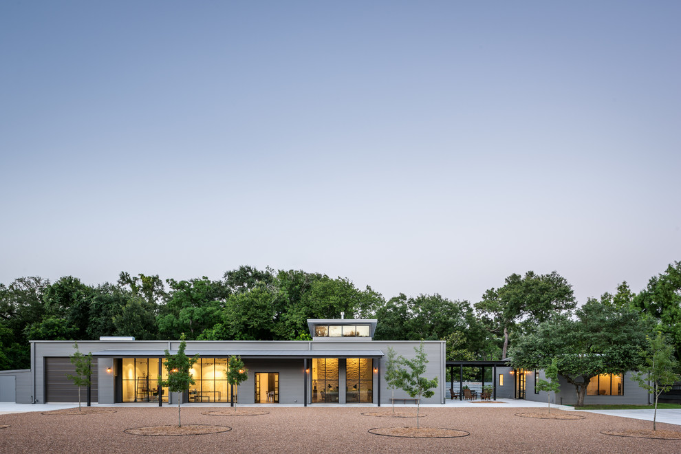 Großes, Einstöckiges Industrial Haus mit Metallfassade, grauer Fassadenfarbe und Satteldach in Houston