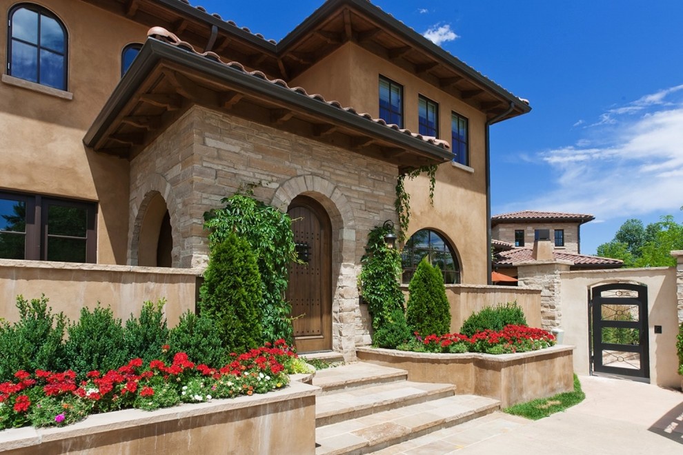 Design ideas for a mediterranean two floor house exterior in Denver.