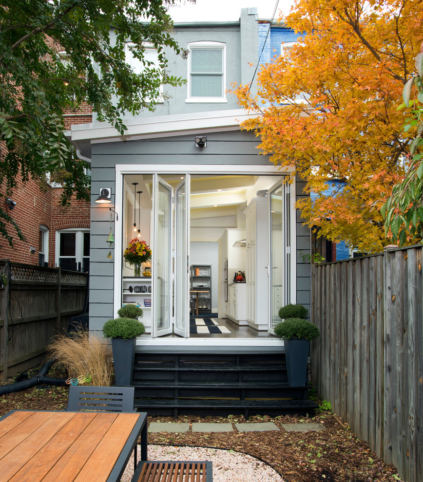 Mid-sized transitional gray three-story wood exterior home photo in DC Metro with a shed roof
