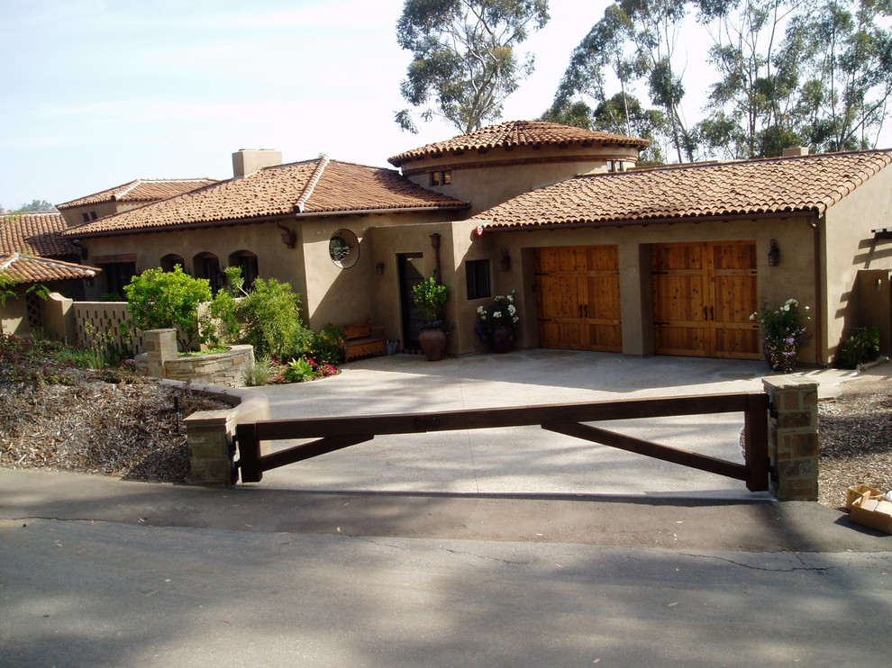 Inspiration for a beige mediterranean render detached house in San Diego with a shingle roof.