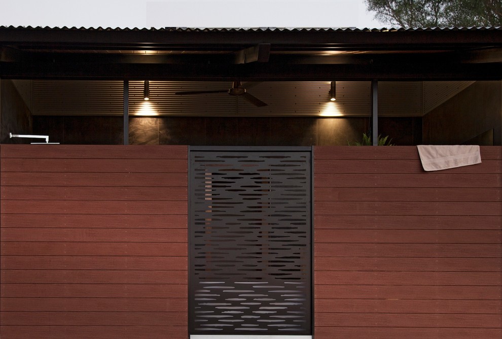 Inspiration for a medium sized and brown world-inspired bungalow house exterior in Darwin with wood cladding.