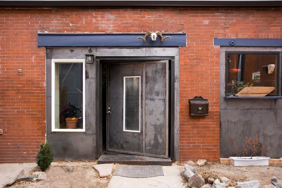 Trendy brick exterior home photo in Denver