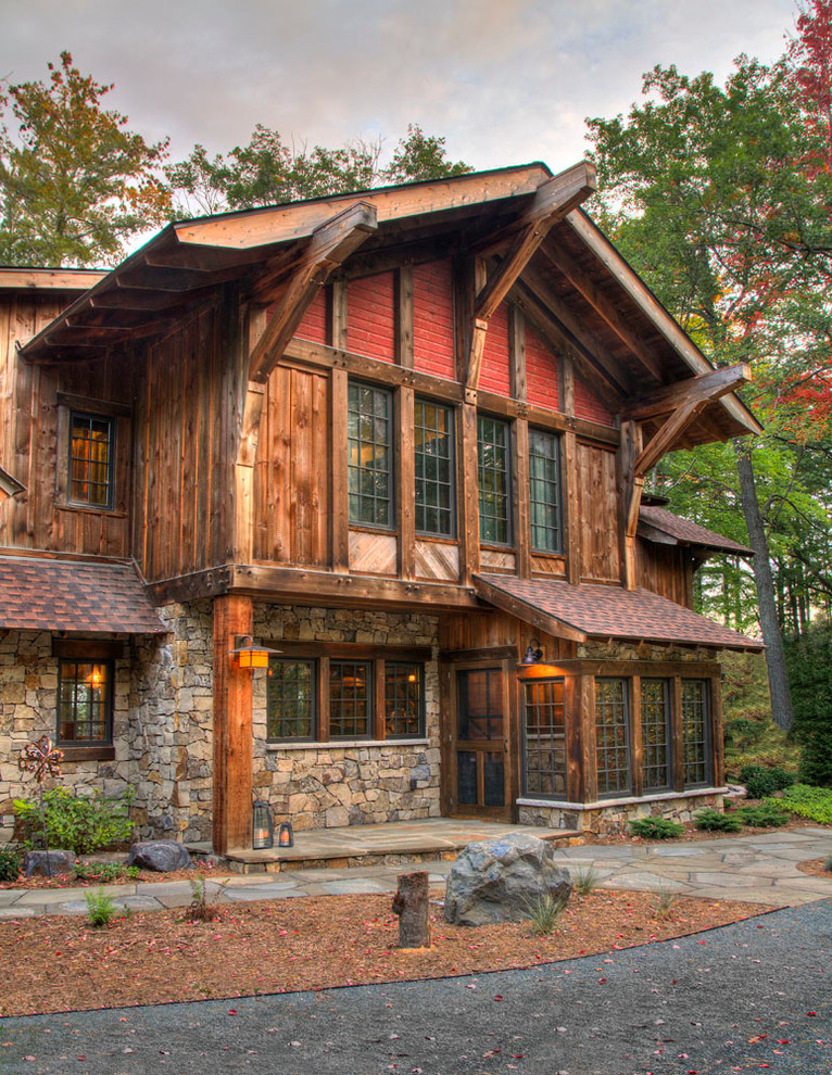 Inspiration for a rustic two floor house exterior in Minneapolis with wood cladding and a pitched roof.