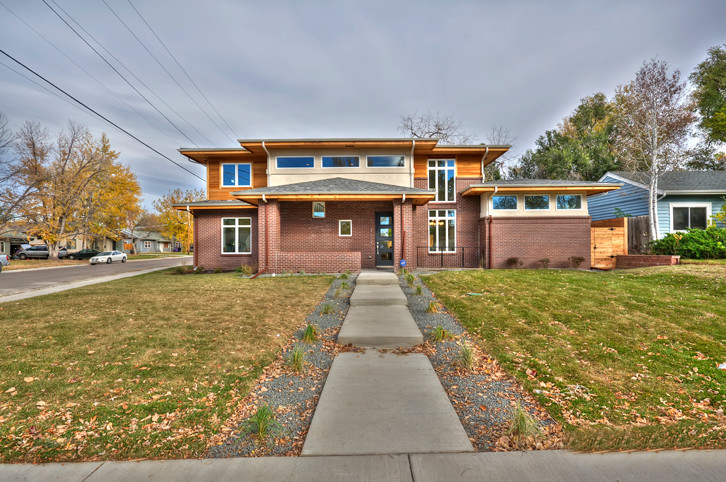 Modern beige two-story brick exterior home idea in Denver