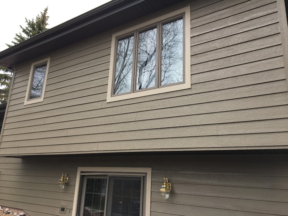 Diamond Kote siding, aluminum Dark bronze soffit and gutters House