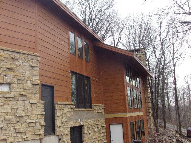 Inspiration for a large rustic brown two-story mixed siding exterior home remodel in Minneapolis