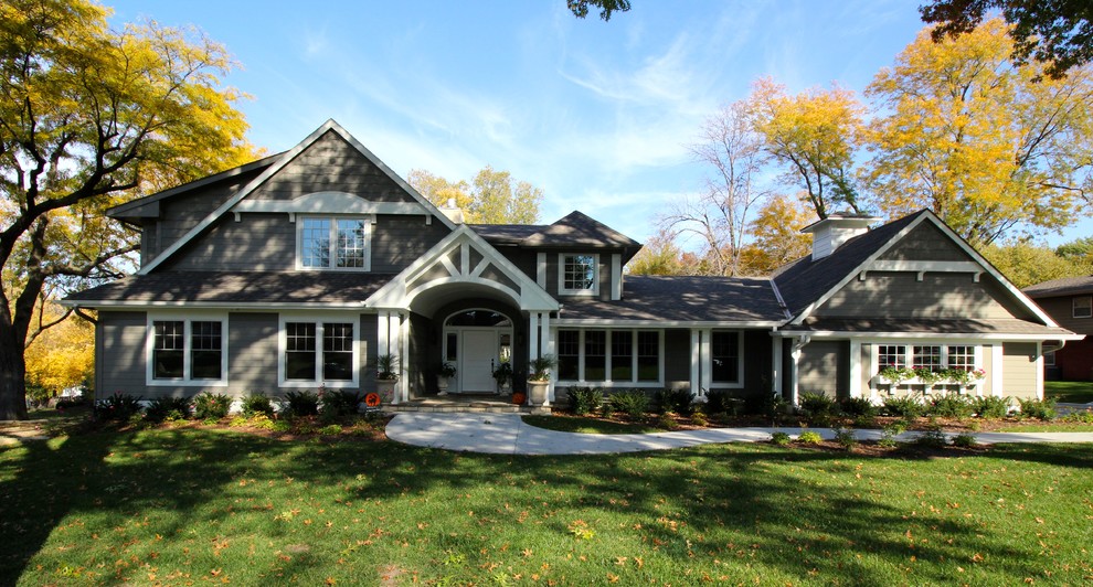 Inspiration for a large modern gray two-story wood house exterior remodel in Omaha with a hip roof and a shingle roof