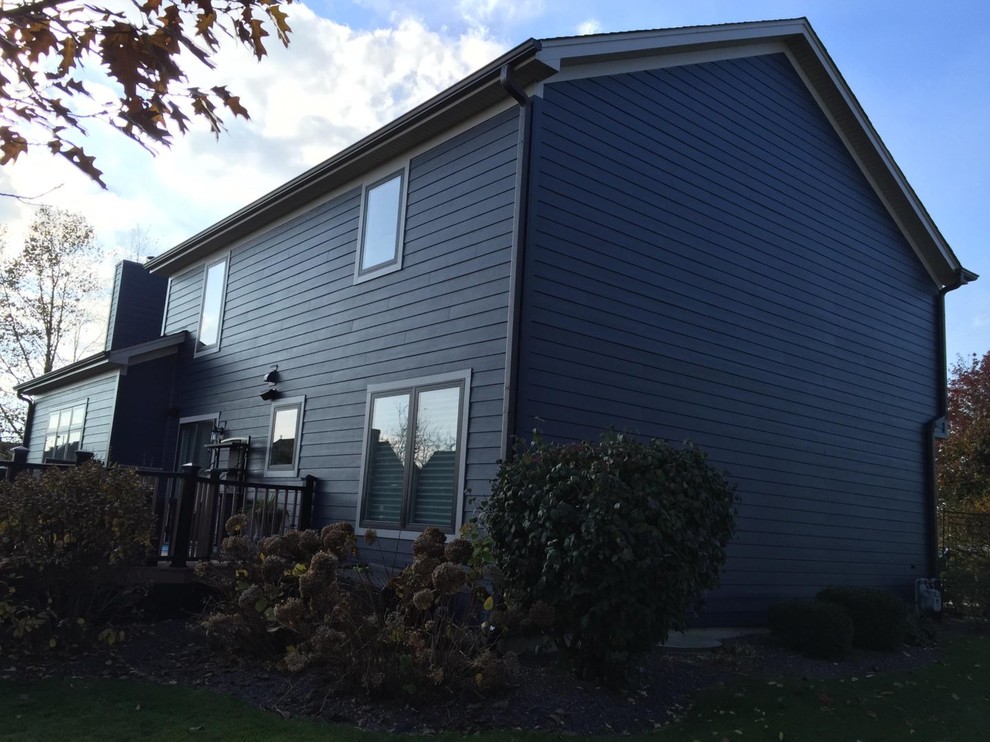 Photo of a medium sized and blue classic two floor house exterior in Chicago with concrete fibreboard cladding and a pitched roof.