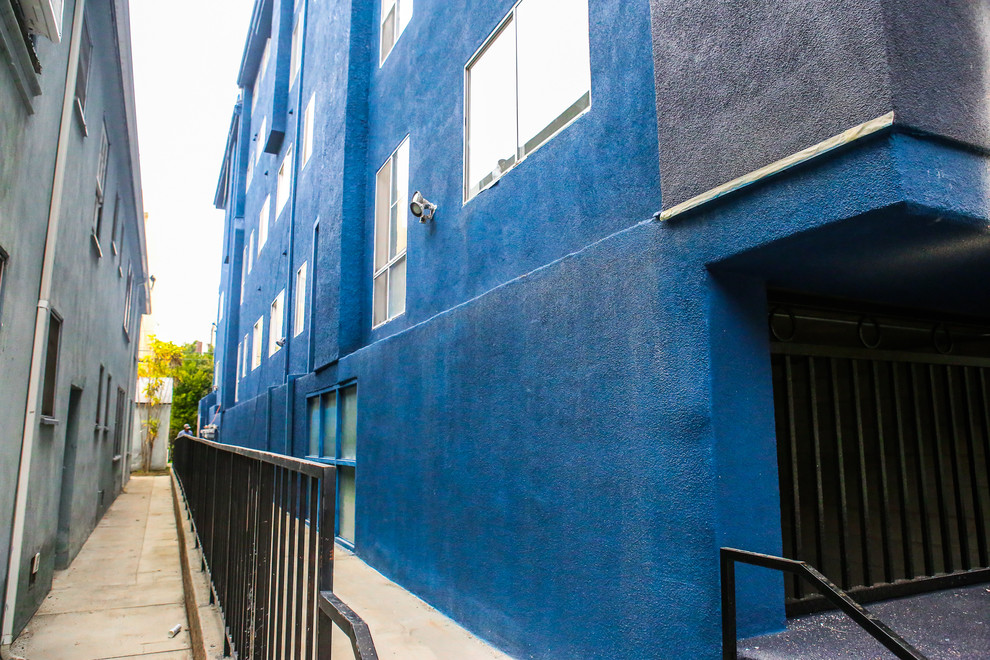 Свежая идея для дизайна: большой, трехэтажный, синий многоквартирный дом в современном стиле с облицовкой из цементной штукатурки - отличное фото интерьера