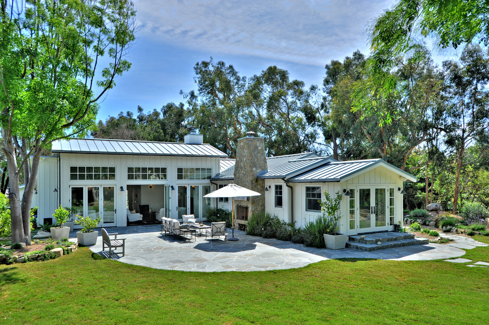 Mid-sized cottage white one-story wood exterior home idea in Los Angeles with a metal roof