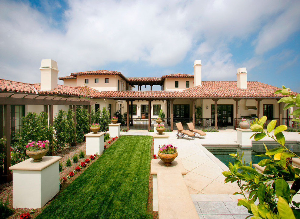 This is an example of a mediterranean two floor house exterior in Los Angeles.
