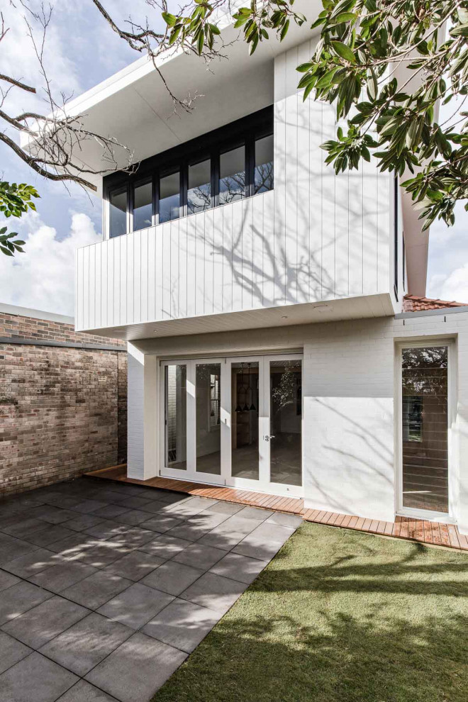 Foto della villa bianca contemporanea a due piani di medie dimensioni con copertura in metallo o lamiera