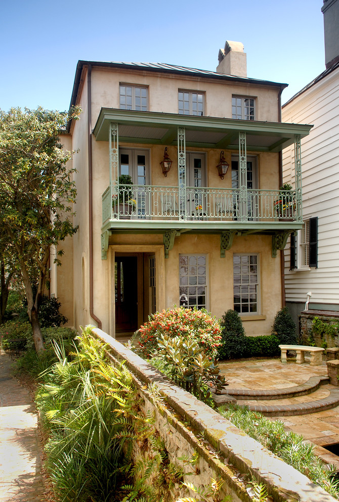 Design ideas for a traditional house exterior in Charleston with three floors.