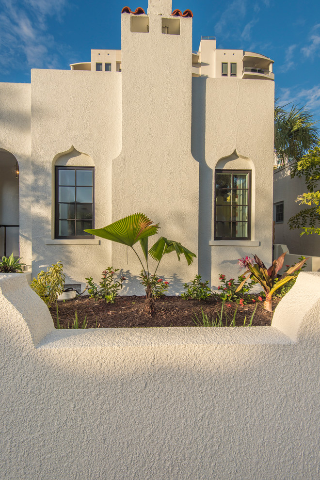 Mid-sized tuscan white one-story stucco exterior home photo in Tampa