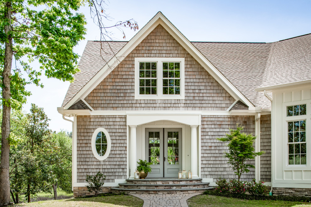 Imagen de fachada de casa beige costera extra grande de dos plantas con revestimientos combinados, tejado a dos aguas y tejado de teja de madera