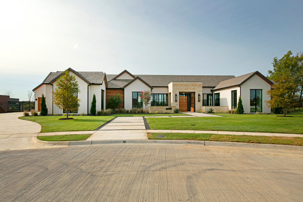 This is an example of a large and white contemporary bungalow detached house in Dallas with stone cladding.