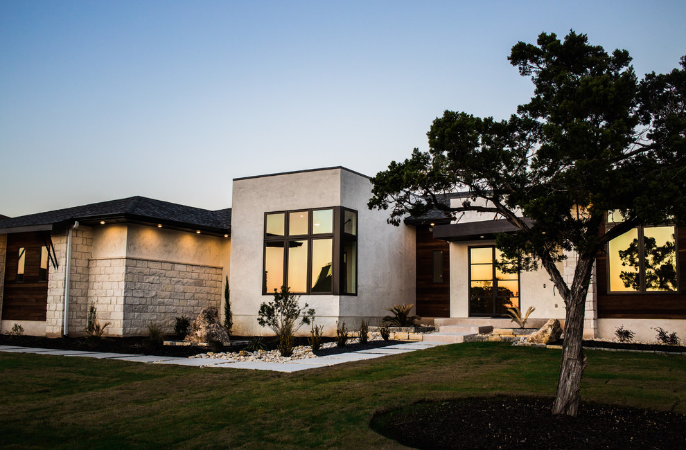 Mittelgroßes, Einstöckiges Modernes Einfamilienhaus mit Putzfassade, beiger Fassadenfarbe und Flachdach in Austin