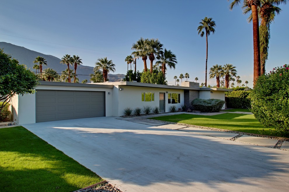 Mid-century modern white one-story flat roof idea in Other
