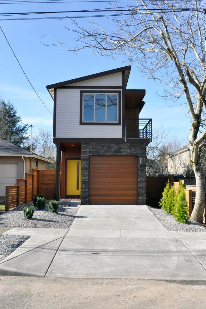 This is an example of a contemporary two floor house exterior in Portland with a lean-to roof.