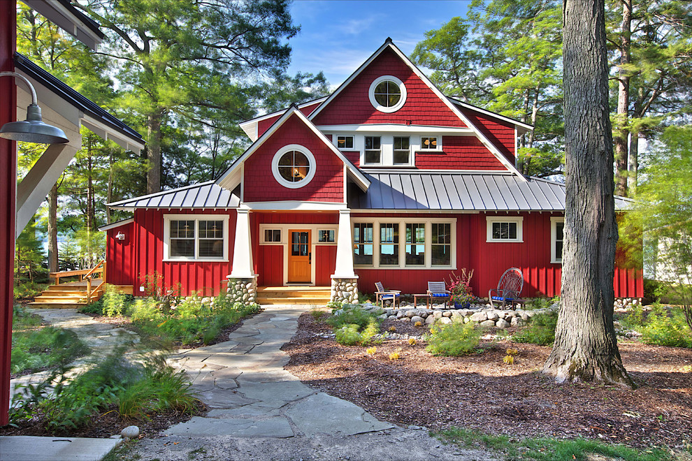 Photo of a red rustic two floor house exterior in Other.