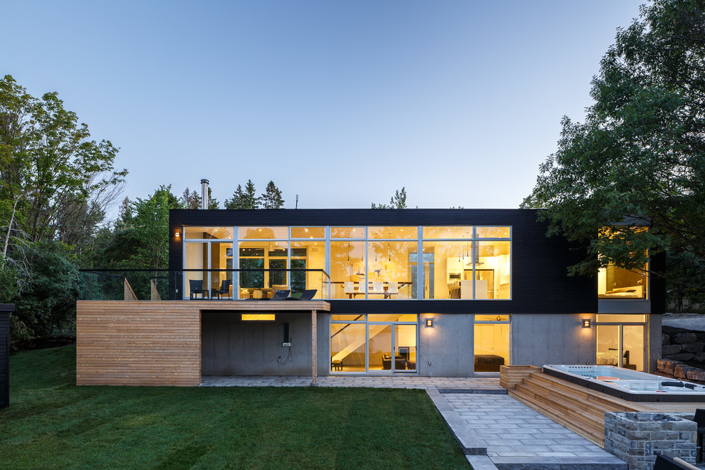 Inspiration for a modern two floor glass house exterior in Ottawa with a flat roof.