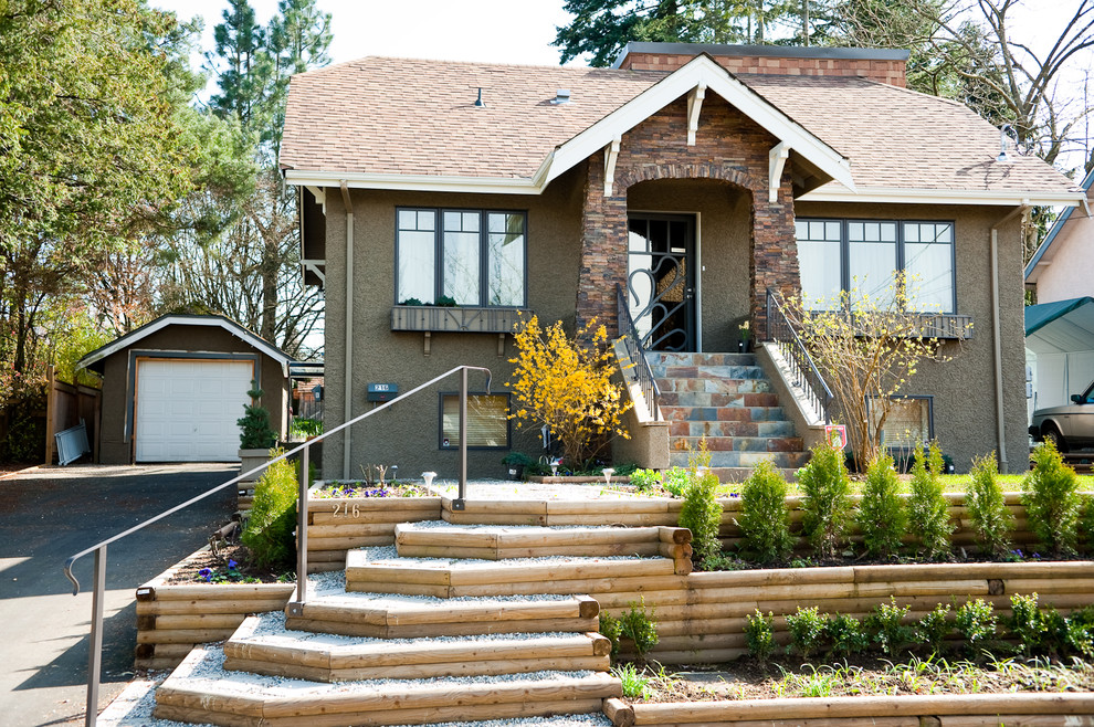 Photo of a medium sized and brown classic render house exterior in Vancouver with a hip roof and three floors.