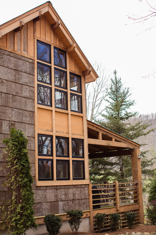 Diseño de fachada marrón rural de tamaño medio de dos plantas con revestimiento de madera y tejado de un solo tendido