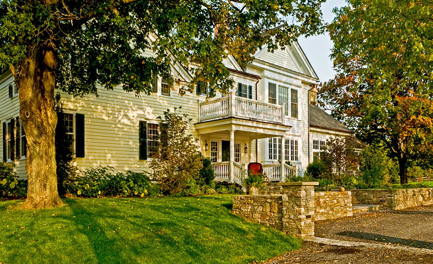 Example of a country exterior home design in New York