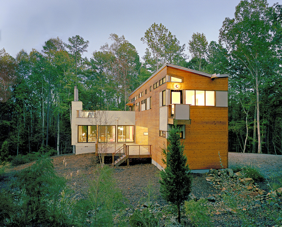 Inspiration for a modern house exterior in Raleigh with wood cladding.