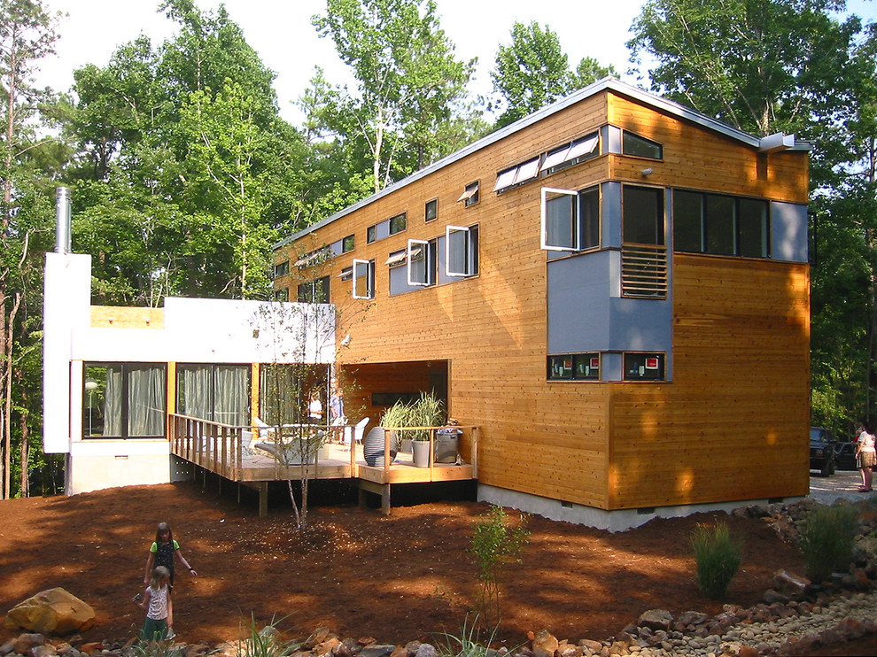 Design ideas for a modern house exterior in Raleigh with wood cladding.