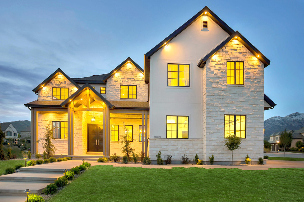 Large traditional two floor house exterior in Salt Lake City with stone cladding and a pitched roof.