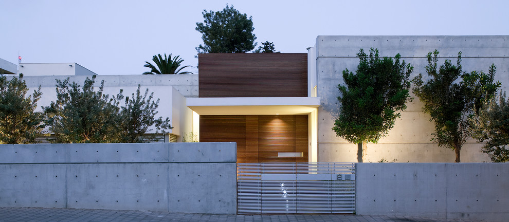 This is an example of a large and gey modern two floor concrete detached house in Other with a flat roof.