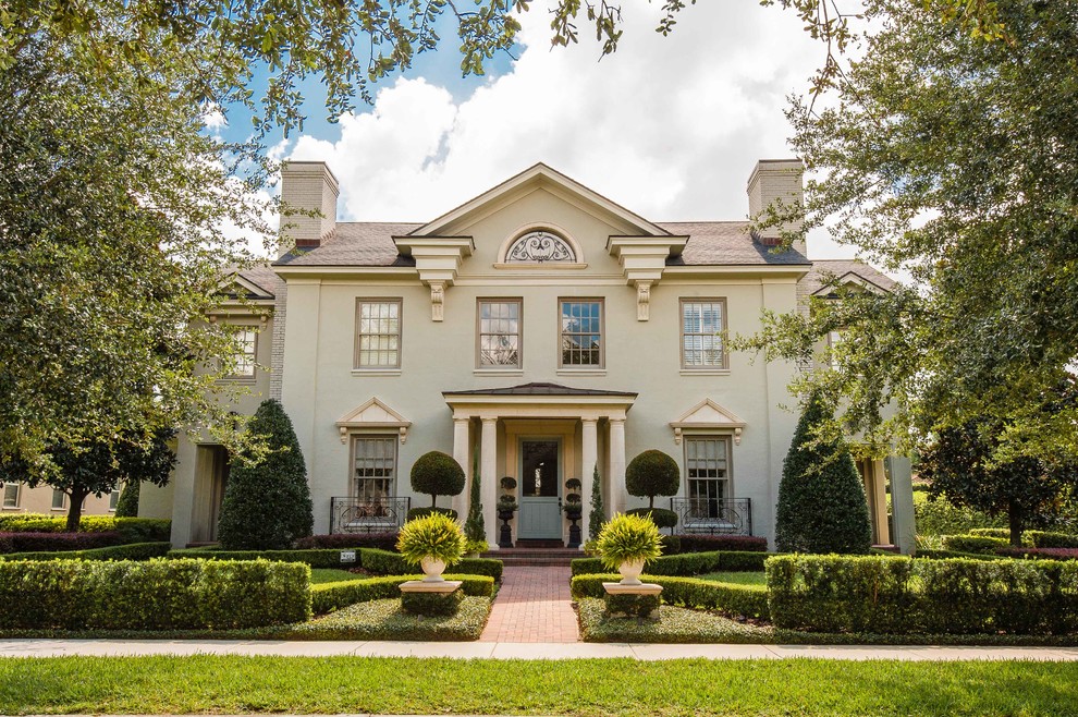 Inspiration for a timeless beige two-story gable roof remodel in Orlando