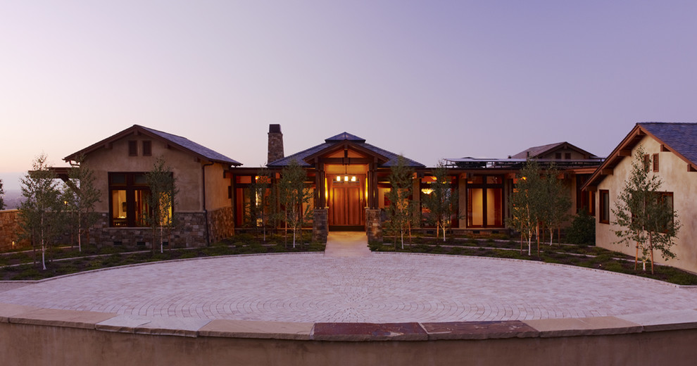 Large trendy beige one-story stone exterior home photo in San Francisco with a mixed material roof