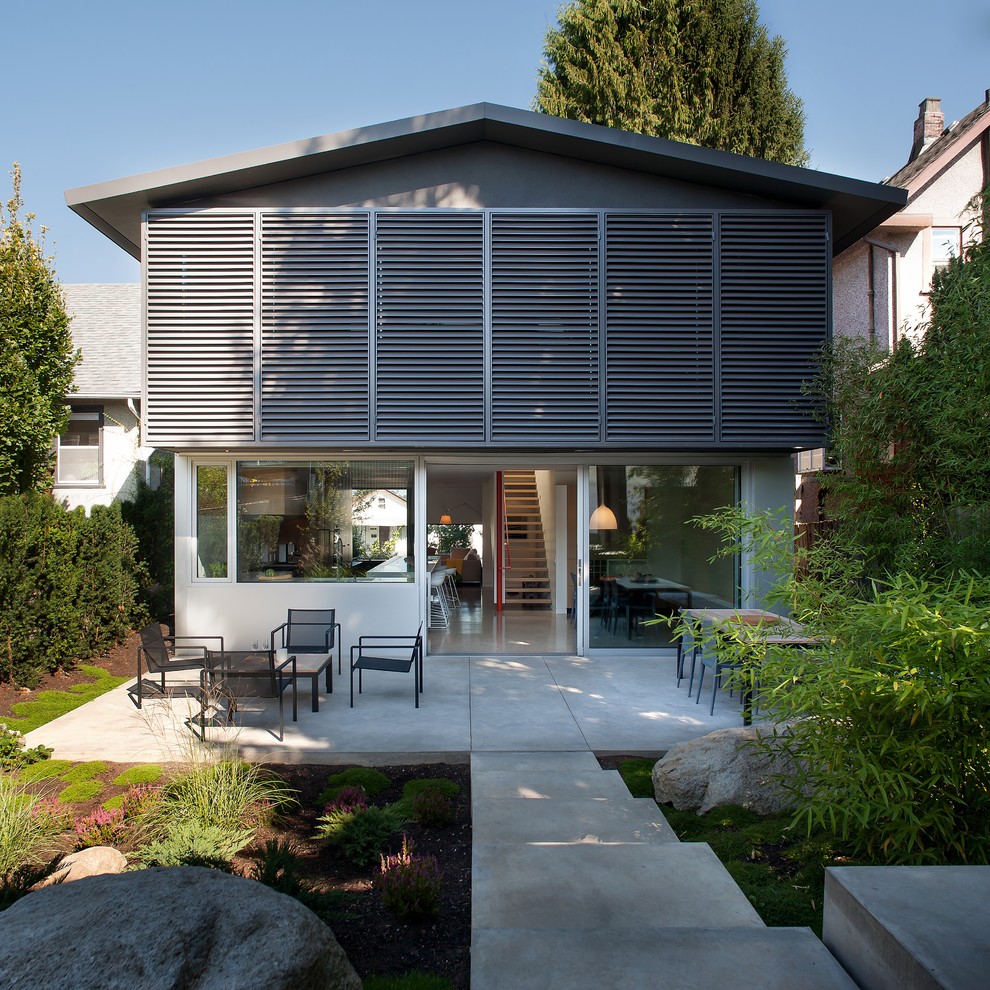 Inspiration for a contemporary two floor house exterior in Vancouver with a pitched roof.