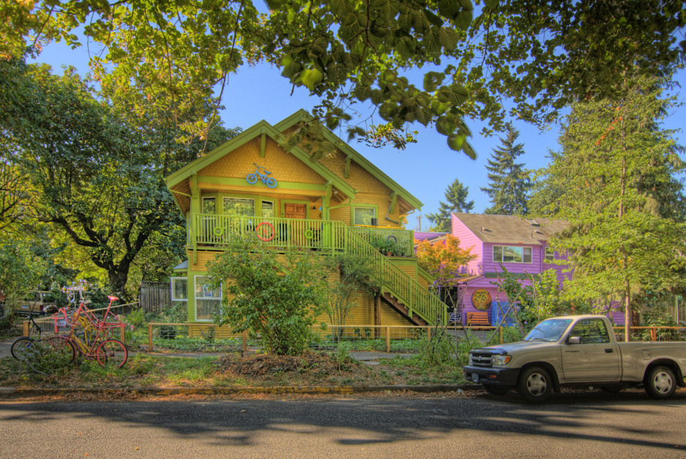 Inspiration for a medium sized and yellow eclectic two floor house exterior in Other with wood cladding.