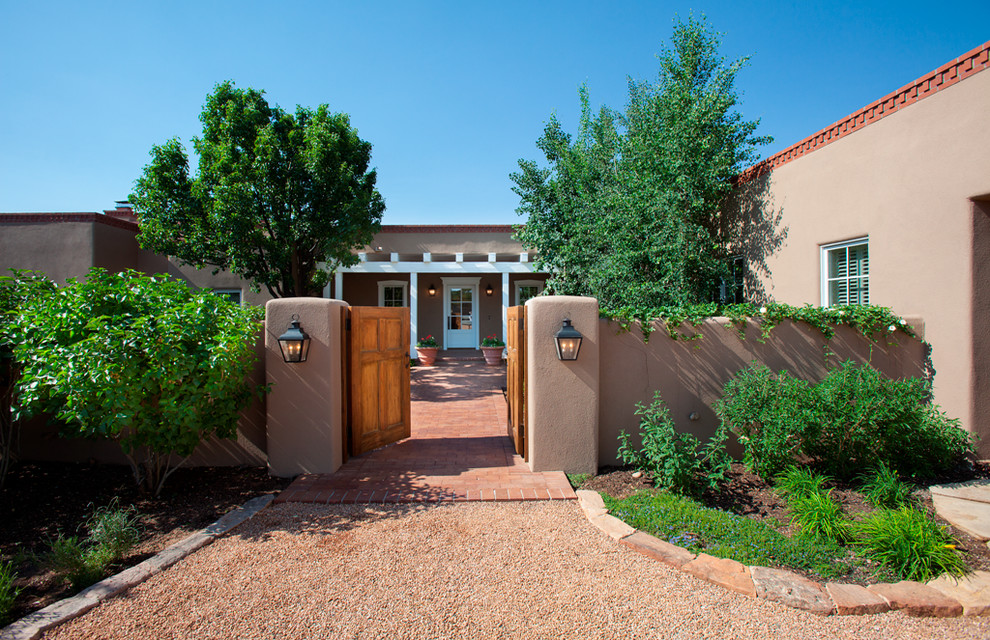 Design ideas for an expansive and brown bungalow clay house exterior in Albuquerque with a flat roof.