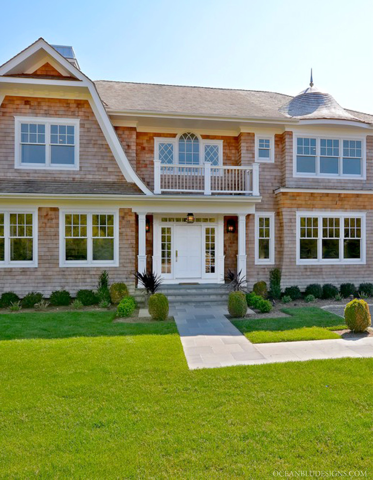 Inspiration for a large timeless beige two-story wood exterior home remodel in New York with a gambrel roof