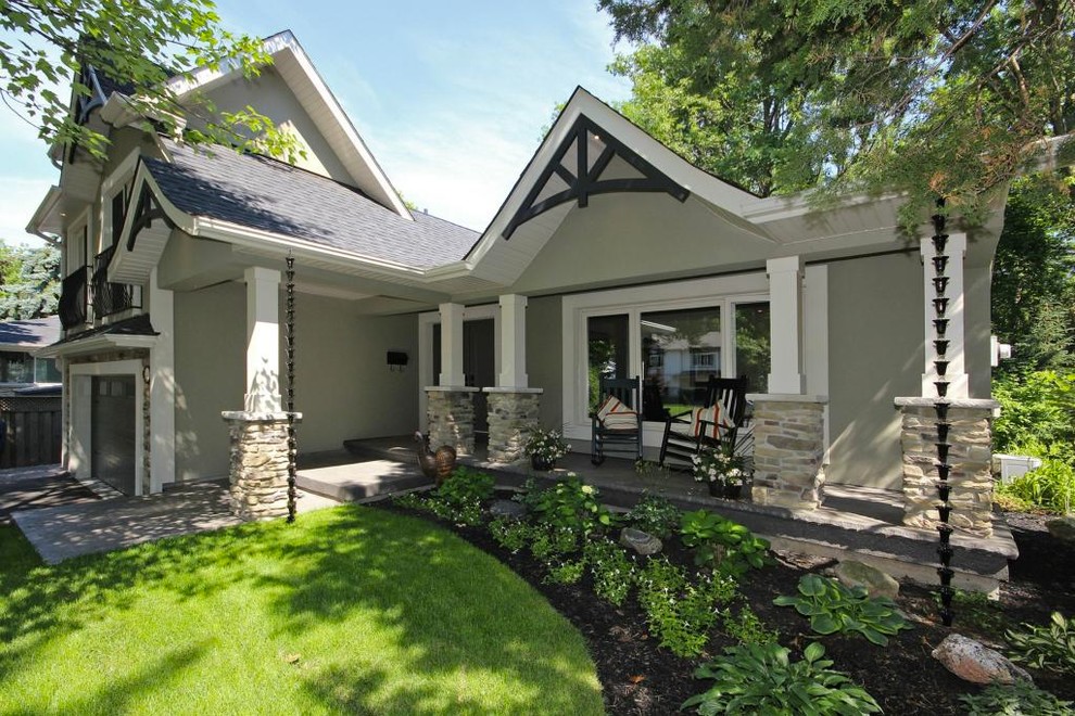 Inspiration for a gey classic two floor render house exterior in Toronto with a pitched roof.