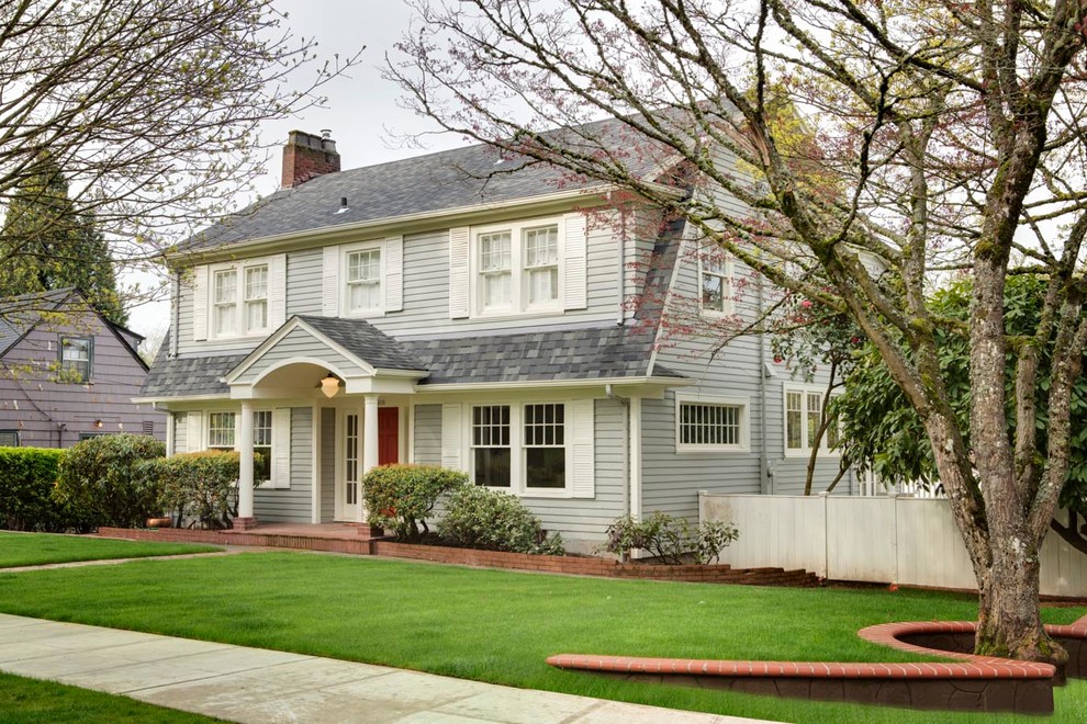 Example of a large classic gray two-story wood exterior home design in Portland