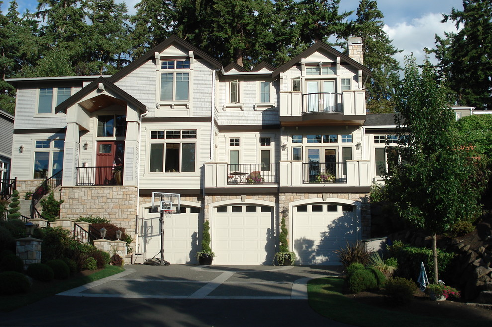 Inspiration for a large timeless beige three-story mixed siding gable roof remodel in Seattle