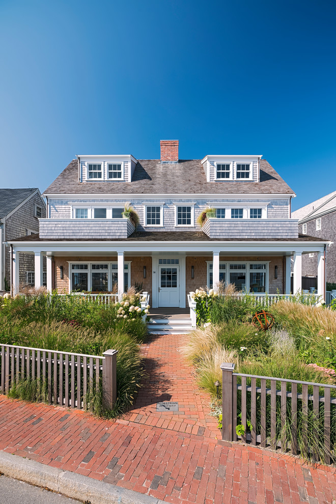 Coastal brown two-story exterior home idea in Other with a shingle roof