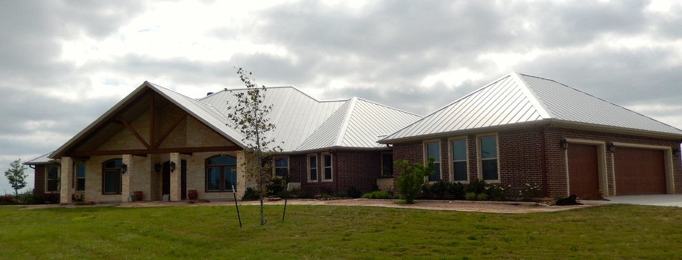 Example of a large eclectic one-story stone exterior home design in Austin with a hip roof
