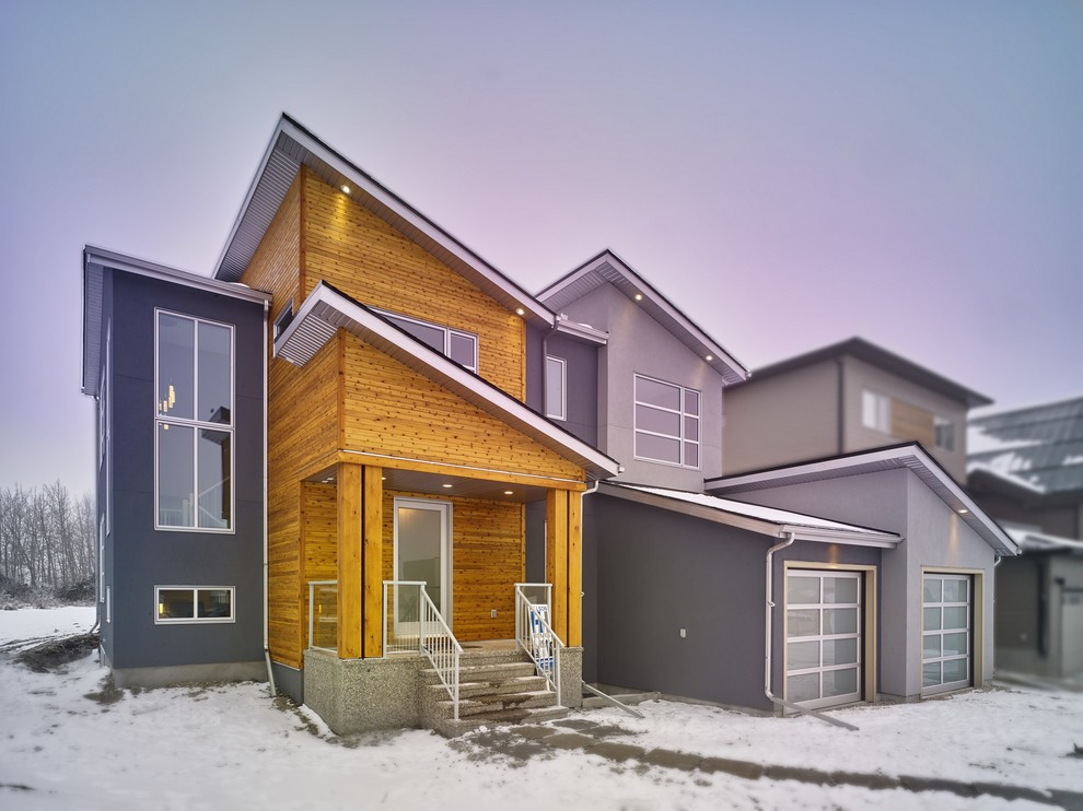 Photo of a gey modern two floor house exterior in Calgary with mixed cladding.