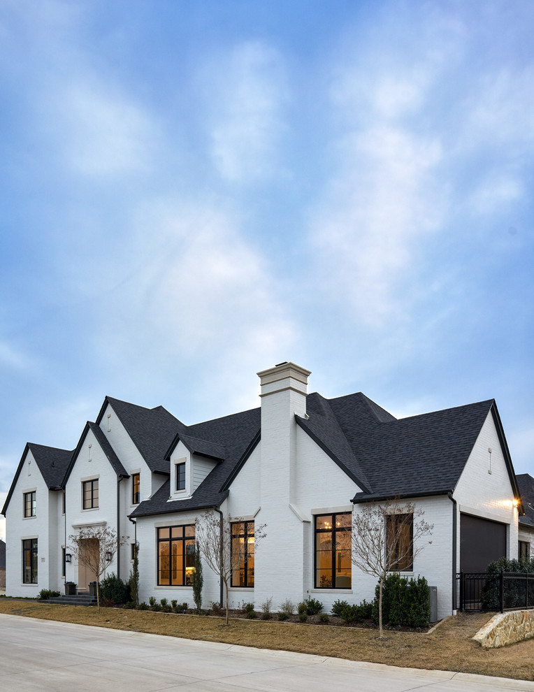 Transitional white two-story brick house exterior photo in Dallas with a shingle roof