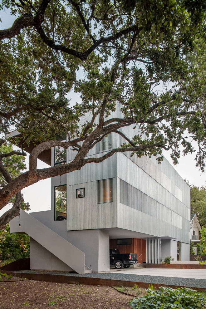 Mid-sized trendy gray three-story metal exterior home photo in Austin