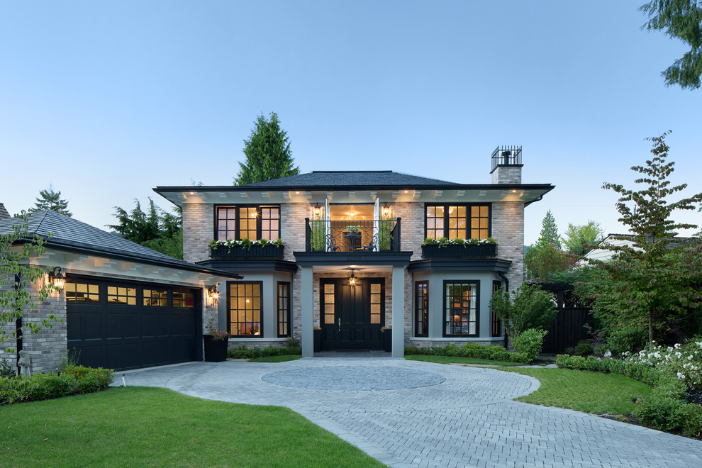 Example of a large classic gray two-story brick exterior home design in Vancouver