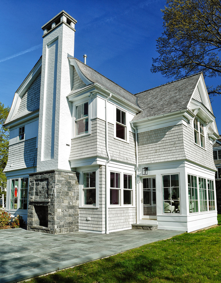 Inspiration for a mid-sized coastal gray two-story wood house exterior remodel in New York with a hip roof and a shingle roof